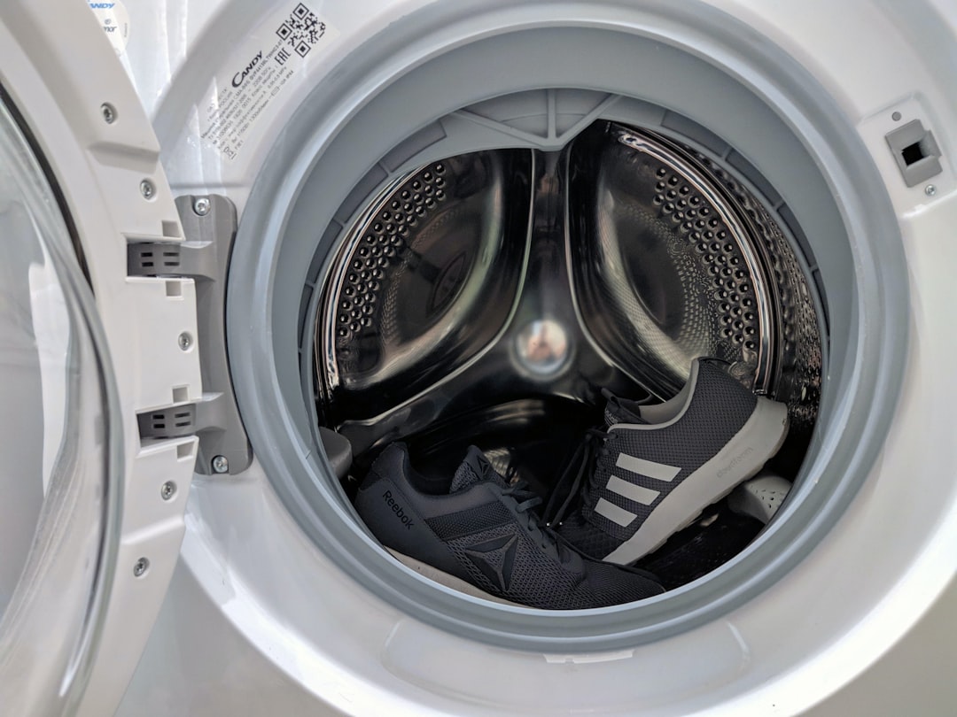 A pair of grey sneakers in the washing machine.